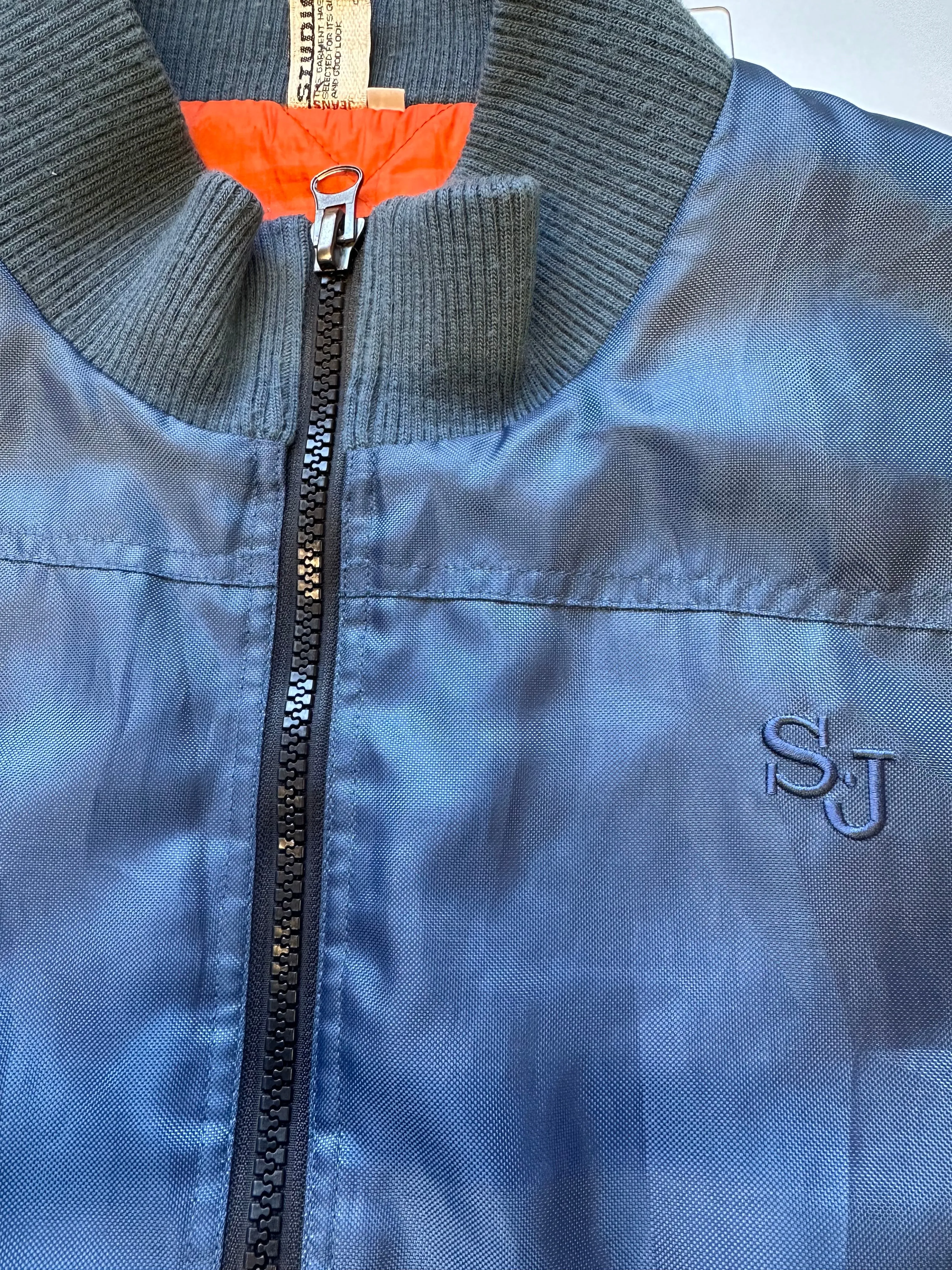 blue zip up bomber jacket